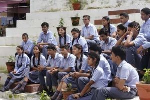 Students sitting on the ground of the one of the best CBSE schools in Dehradun, - Manav Bharti